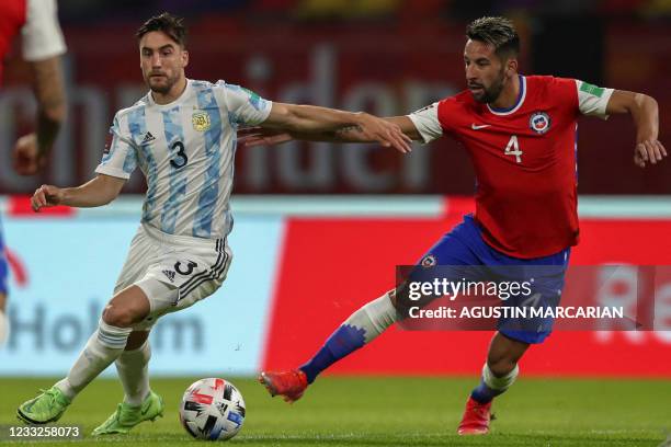 Argentina's Nicolas Tagliafico and Chile's Mauricio Isla vie for the ball during their South American qualification football match for the FIFA World...