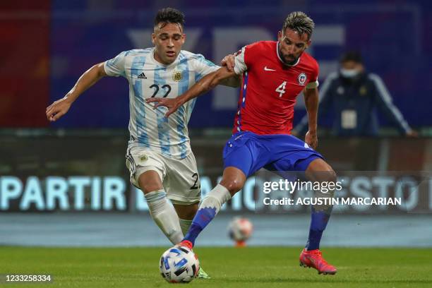 Argentina's Lautaro Martinez and Chile's Mauricio Isla vie for the ball during their South American qualification football match for the FIFA World...