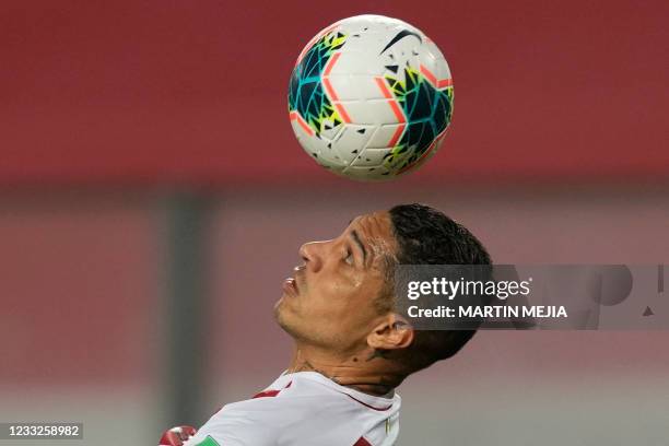 Peru's Paolo Guerrero heads the ball during the South American qualification football match for the FIFA World Cup Qatar 2022 against Colombia at the...