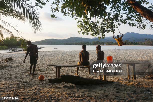 Teenagers are seen at the Black Johnson beach, near Freetown, Sierra Leone, on May 23, 2021. - Sierra Leoneans are protesting a planned industrial...