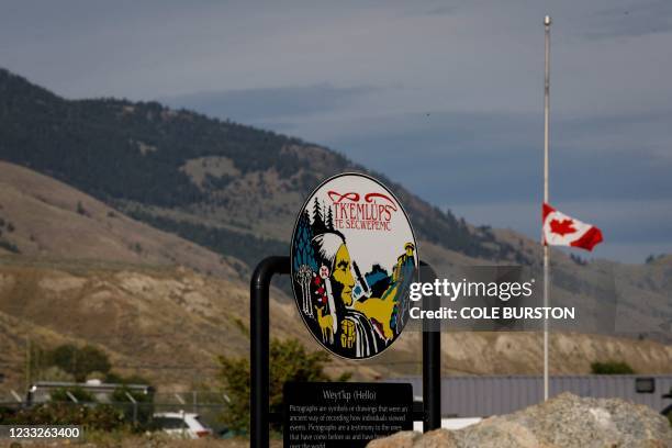 Canadian flag hangs at half mast at the Tkemlups RCMP detachment near the former Kamloops Indian Residential School in Kamloops, British Columbia,...