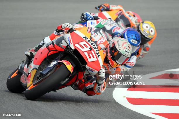 Honda Spanish rider Marc Marquez, Honda-LCR Spanish rider Alex Marquez and Honda Spanish rider Pol Espargaro ride during the first MotoGP free...