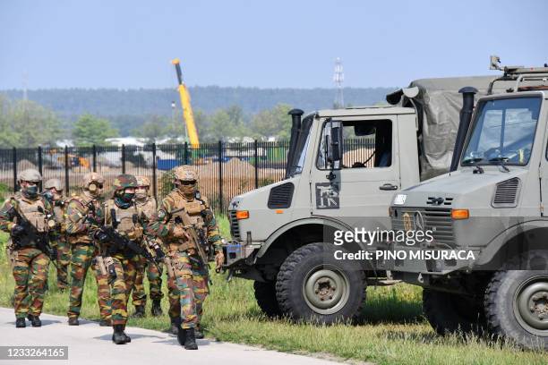 Heavily armed soldiers take part in an intensive sweeping of an area on the edge of the Nationaal Park Hoge Kempen in Maasmechelen on June 4...
