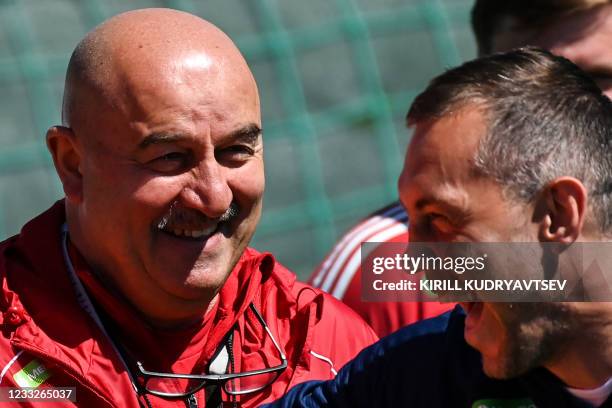 Head coach Stanislav Cherchesov and forward Artem Dzyuba take part in a training session of the Russian national football team at the Novogorsk...