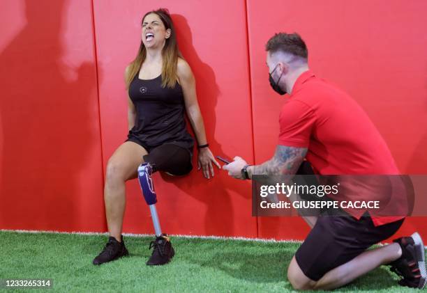 Amputee athlete Darine Barbar attempts to break the Guinness World Records title for the Longest Samson's chair/static wall sit, in Dubai on June 4,...