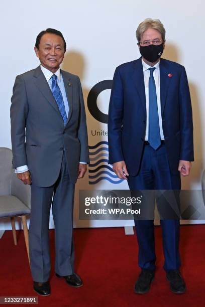 Japan's Finance Minister Taro Aso and European Commissioner for Economy Paolo Gentiloni pose for a photograph during their meeting on the first day...