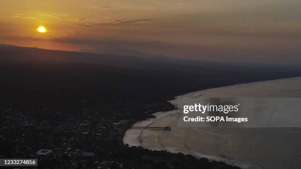 Aerial view of the sun as it rises over the beach. El Salvador hosts the ISA World Surfing Games where the winners will be given tickets to the Tokyo...