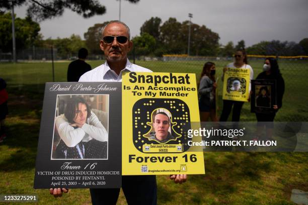 Jaime Puerta holds a portrait of his son Daniel Puerta-Johnson, who died in April 2020 at the age of 16 from fentanyl poisoning, before protesting...