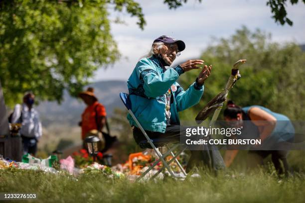 Kamloops Indian Residential School survivor Stanley Paul sits by a growing makeshift memorial at the former residential school to honour the 215...