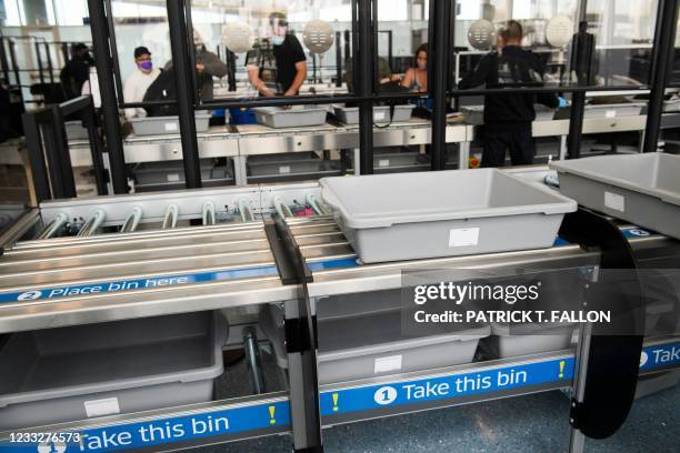 Travelers enter a new Transportation Security Administration screening area during the opening of the Terminal 1 expansion at Los Angeles...