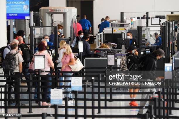 Travelers enter a new Transportation Security Administration screening area during the opening of the Terminal 1 expansion at Los Angeles...