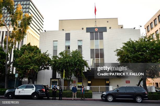 Police officers stand guard as people attend a vigil commemorating the 32nd anniversary of the 1989 Tiananmen square pro-democracy protests and...