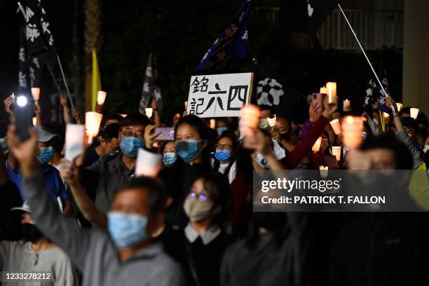 People attend a vigil commemorating the 32nd anniversary of the 1989 Tiananmen square pro-democracy protests and crackdown outside of the Chinese...