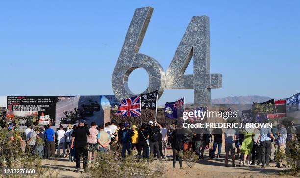 People gather around the 6-4, representing June 4th, sculpture at the Liberty Sculpture Park in the Mojave desert town of Yermo, California on June 4...