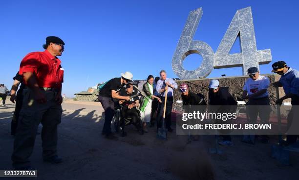 Artist and sculptor Chen Weiming looks on during a ceremony at Liberty Sculpture Park by a group of people, including New Jersey Congressman Chris...