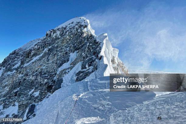 This photograph taken on May 31, 2021 shows mountaineers climbing the Hillary Step during their ascend of the South face to summit Mount Everest , in...