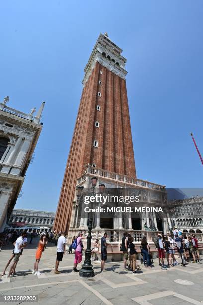 Tourists line up to visit the Bell Tower at St. Mark's square in Venice on June 05, 2021.