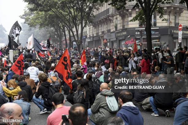 Demonstrators and anti-fascist activists sit on the ground in the street during a demonstration in Paris, on June 5 a day after two ex-skinheads...