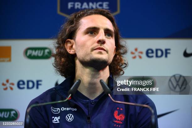 France's midfielder Adrien Rabiot looks on during a press conference in Clairefontaine-en-Yvelines on June 5, 2021 as part of the team's preparation...