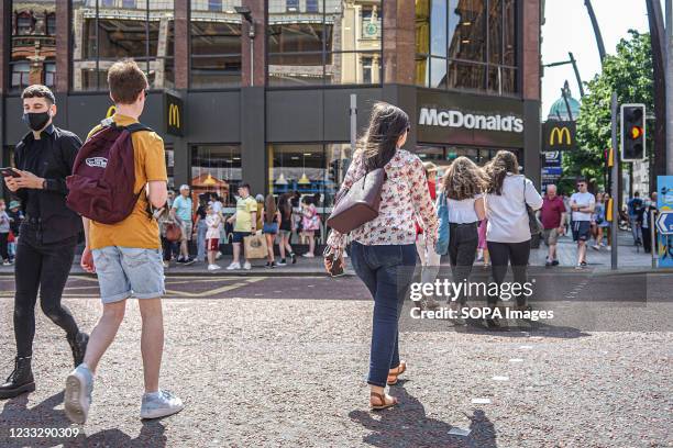 Shoppers walk past McDonald's restaurant on High Street in Belfast.