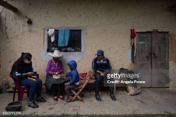 Relatives of Peru's presidential candidate Pedro Castillo, shell corn from their own harvest on June 5, 2021 in Tacabamba, Peru. Peruvians will vote...