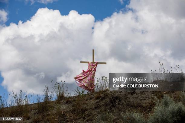 Staked child's dress blows in the wind on Highway 5, representing an ongoing genocide against First Nations people in Canada, near the former...