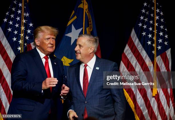 Former U.S. President Donald Trump, left, takes the stage with NCGOP Chairman Michael Whatley after being announced at the NCGOP state convention on...