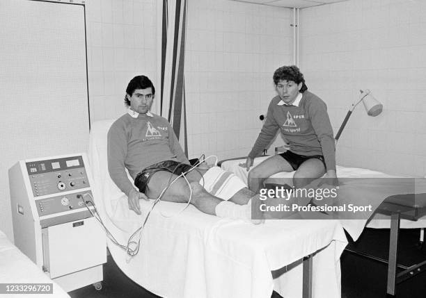 Tottenham Hotspur footballers Paul Miller and Clive Allen in the treatment room at Cheshunt Training Ground nar Broxbourne, England, circa February...