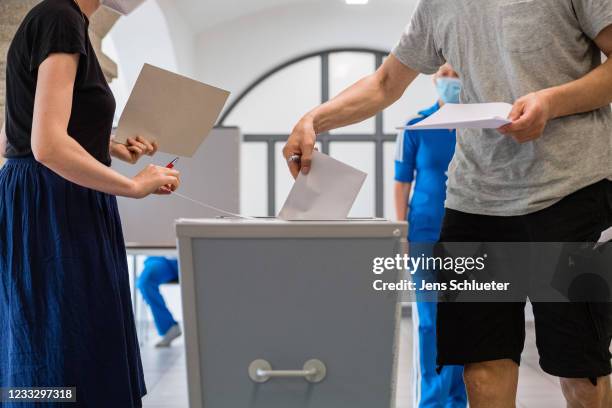 Voters cast their ballots in Saxony-Anhalt state elections on June 6, 2021 in Wittenberg, Germany. Polls show the election is a tight race between...