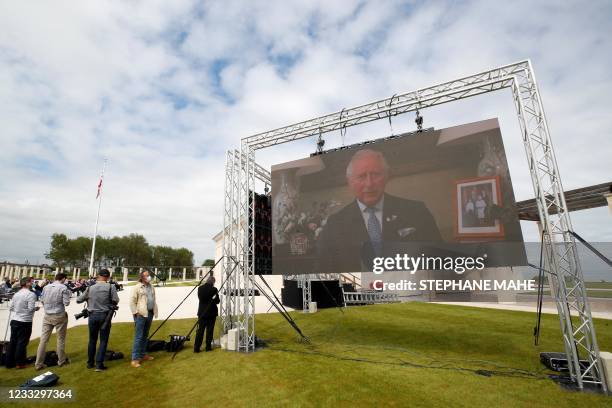 Britain's Prince Charles is seen on a screen as he attends via videoconference the official opening ceremony of the British Normandy Memorial at...