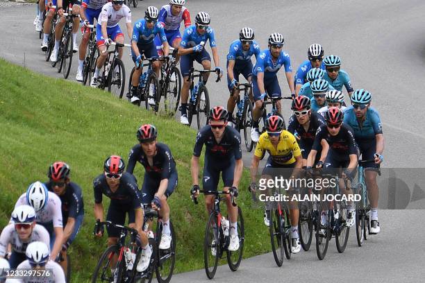 Team Ineos' Richie Porte of Australia wearing the overall leader's yellow jersey rides in the pack during the eighth stage of the 73rd edition of the...