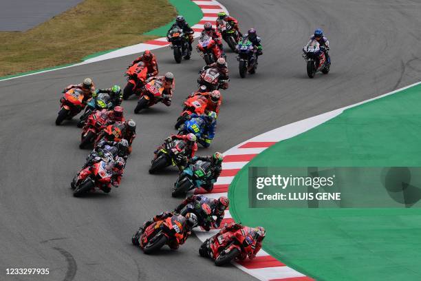 Riders compete at the start of the MotoGP race of the Moto Grand Prix de Catalunya at the Circuit de Catalunya on June 6, 2021 in Montmelo on the...