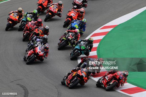 Riders compete at the start of the MotoGP race of the Moto Grand Prix de Catalunya at the Circuit de Catalunya on June 6, 2021 in Montmelo on the...
