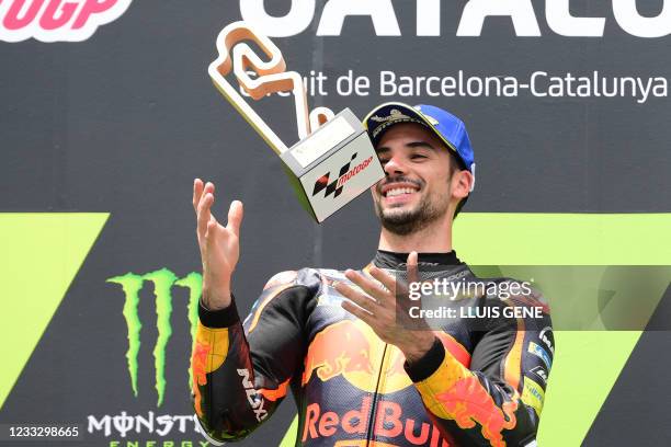 Portuguese rider Miguel Oliveira celebrates on the podium after winning the MotoGP race of the Moto Grand Prix de Catalunya at the Circuit de...