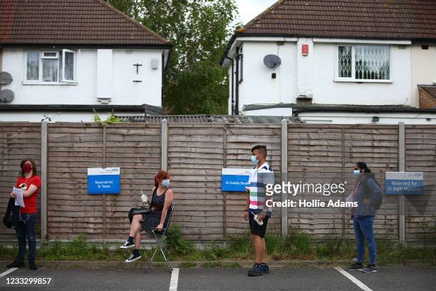 People line up to receive a vaccination on June 6, 2021 in Stanmore, Greater London. Belmont Health Centre saw long queues over the weekend after...