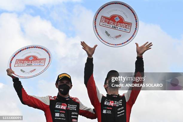 French driver Sebastien Ogier and French co-driver Julien Ingrassia celebrate on the podium in Olbia on June 06, 2021 after winning the Rally of...