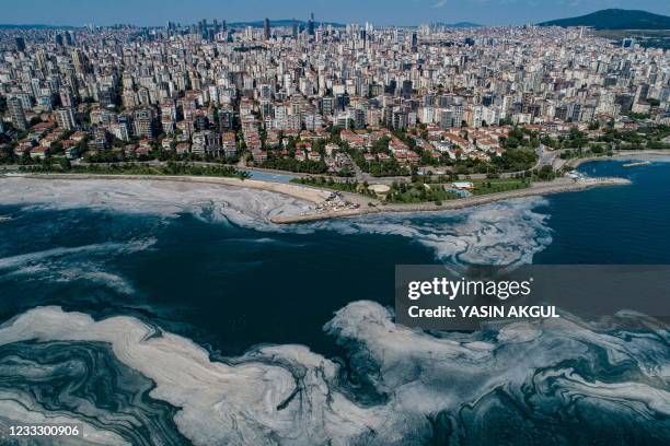 This aerial photograph taken on June 6, 2021 in Turkey's Marmara Sea at a harbor on the shoreline of Istanbul shows mucilage, a jelly-like layer of...