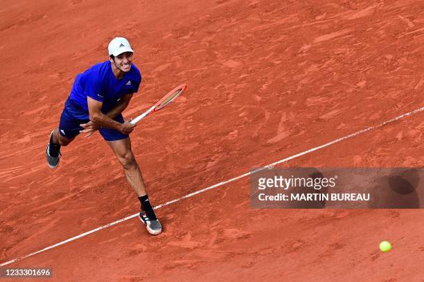 Chile's Christian Garin serves the ball to Russia's Daniil Medvedev during their men's singles fourth round tennis match on Day 8 of The Roland...