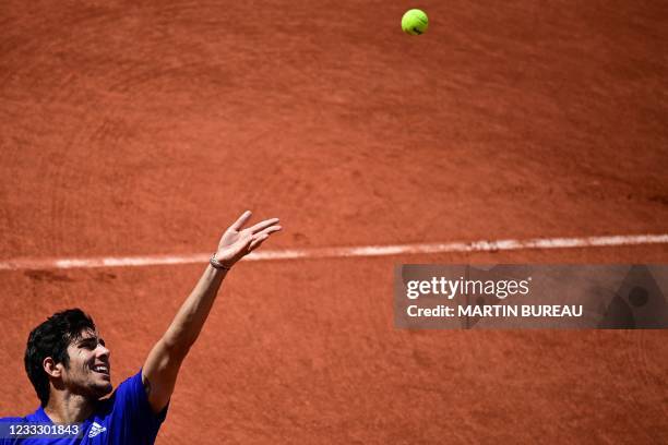 Chile's Christian Garin serves the ball to Russia's Daniil Medvedev during their men's singles fourth round tennis match on Day 8 of The Roland...