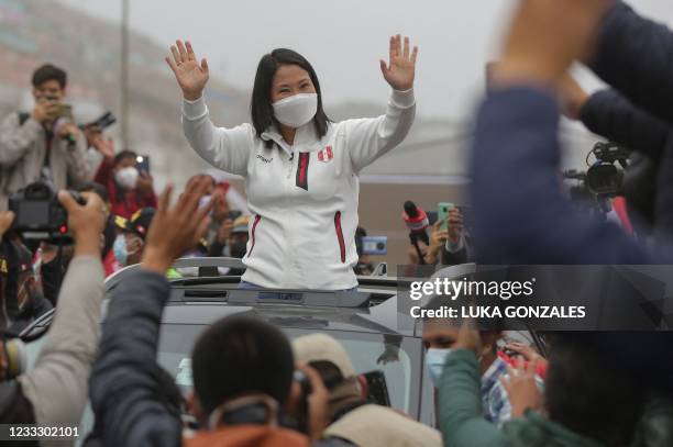 Peruvian right-wing presidential candidate Keiko Fujimori, waves to supporters as she leaves after having breakfast with her family at San Juan de...