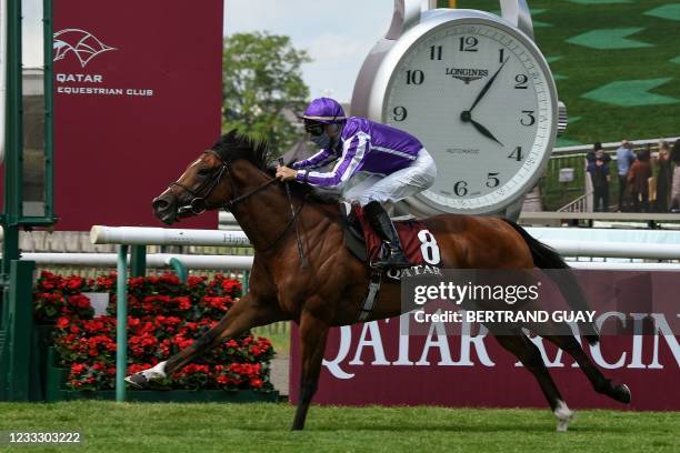 Spanish jockey Ioritz Mendizabal rides St. Mark's Basilica as he crosses the finish line of the 181st edition of The Prix du Jockey-Club horse race...