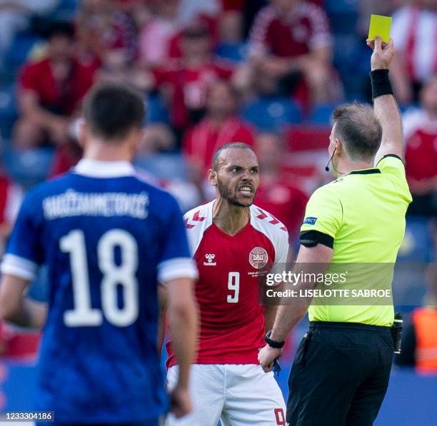 Denmark's forward Martin Braithwaite argues with referee Petri Viljanen who gives him a yellow card during the friendly football match Denmark v...