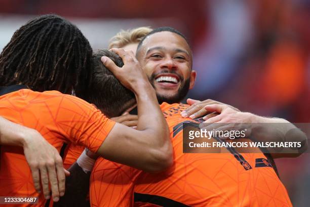 Netherlands' forward Memphis Depay celebrates with teammates the team's second goal during the friendly football match between Netherlands and...
