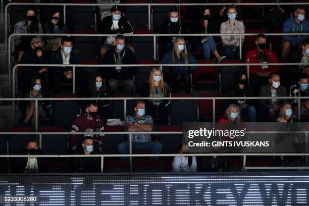 Spectators wear protective face masks to protect against the coronavirus as they watch the IIHF Men's Ice Hockey World Championships final match...