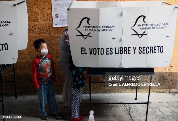 Woman casts her vote at a polling station, in Mexico City, on June 6, 2021. - Mexicans began voting Sunday in elections seen as pivotal to President...