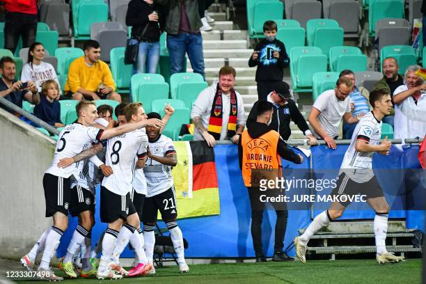 Germanys players celebrate after scoring during the 2021 UEFA European Under-21 Championship final football mat thech between Germany and Portugal at...