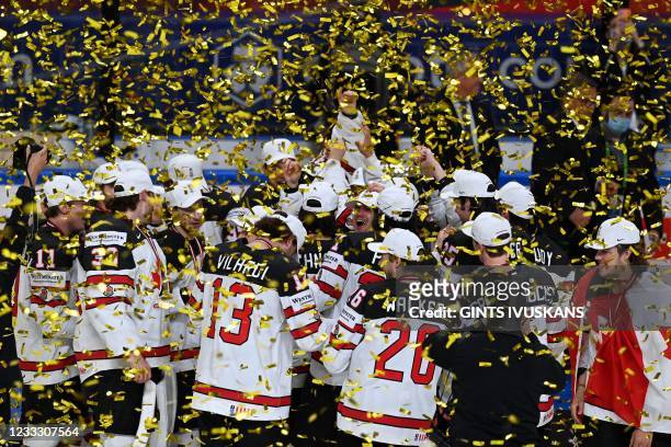 Canada's players celebrate under a confetti shower after winning the IIHF Men's Ice Hockey World Championships final match between the Finland and...
