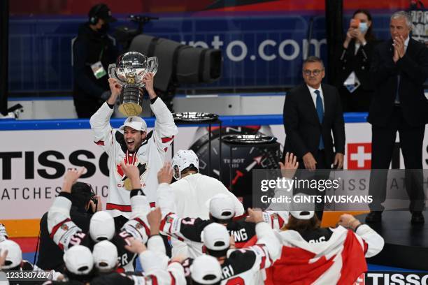 Canada's forward Adam Henrique holds up the trophy as Canada's players celebrate with the trophy after winning the IIHF Men's Ice Hockey World...