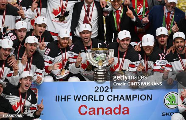 Canada's forward Adam Henrique and teammates pose with the trophy after winning the IIHF Men's Ice Hockey World Championships final match between the...