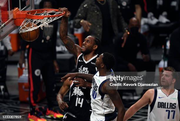 Kawhi Leonard of the Los Angeles Clippers dunks the ball against Dorian Finney-Smith of the Dallas Mavericks during the first half of Game Seven of...